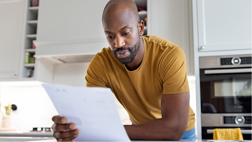 Man looking at his bill. 