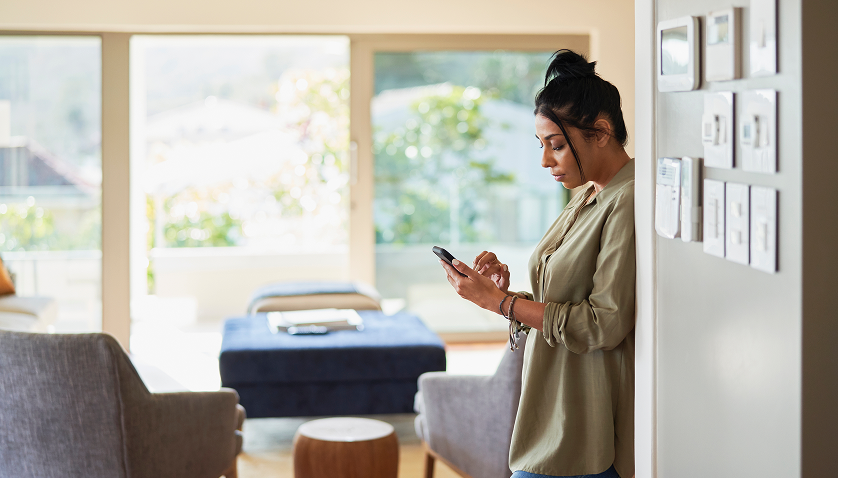 A homeowner using their phone to do the HomeBoost self-guided home energy assessment. 